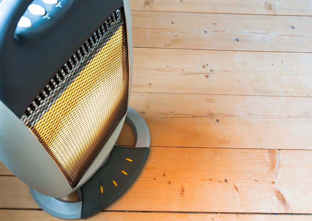 A halogen or electric heater on wooden floor